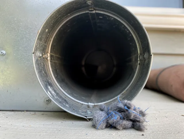 Winter Haven Dryer Vent Cleaning technician using specialized equipment to clear severe dryer vent blockage in Winter Haven